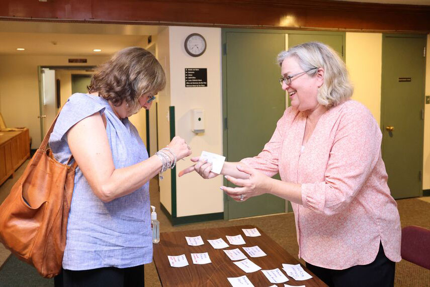 Ladies putting on name tags